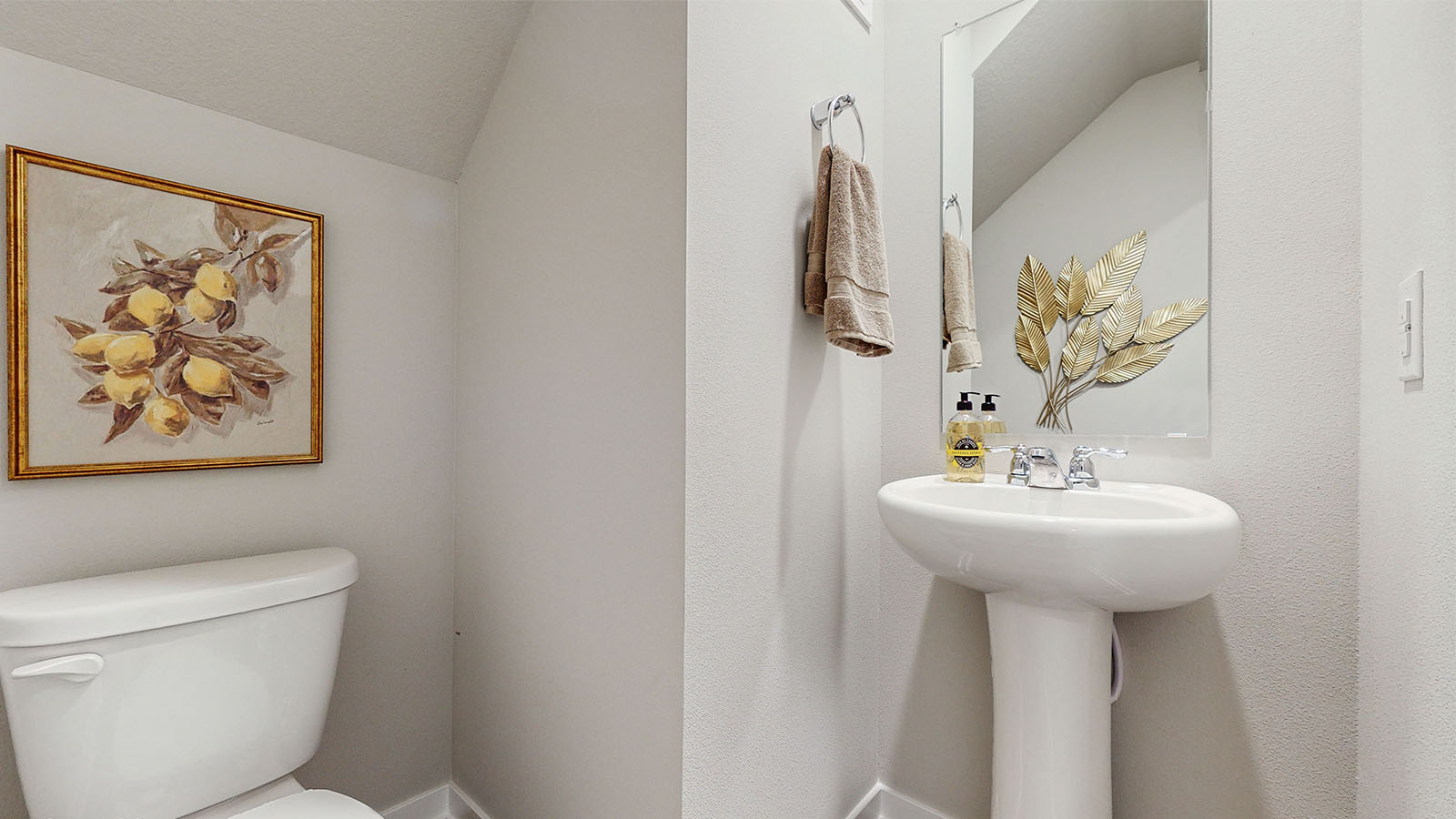 Convenient main-level powder room with updated fixtures and bright lighting.