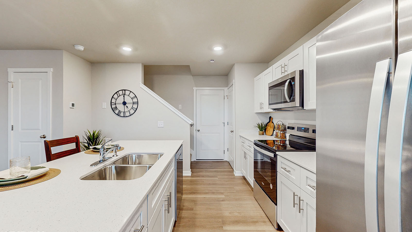 Kitchen with white cabinetry and quartz countertop