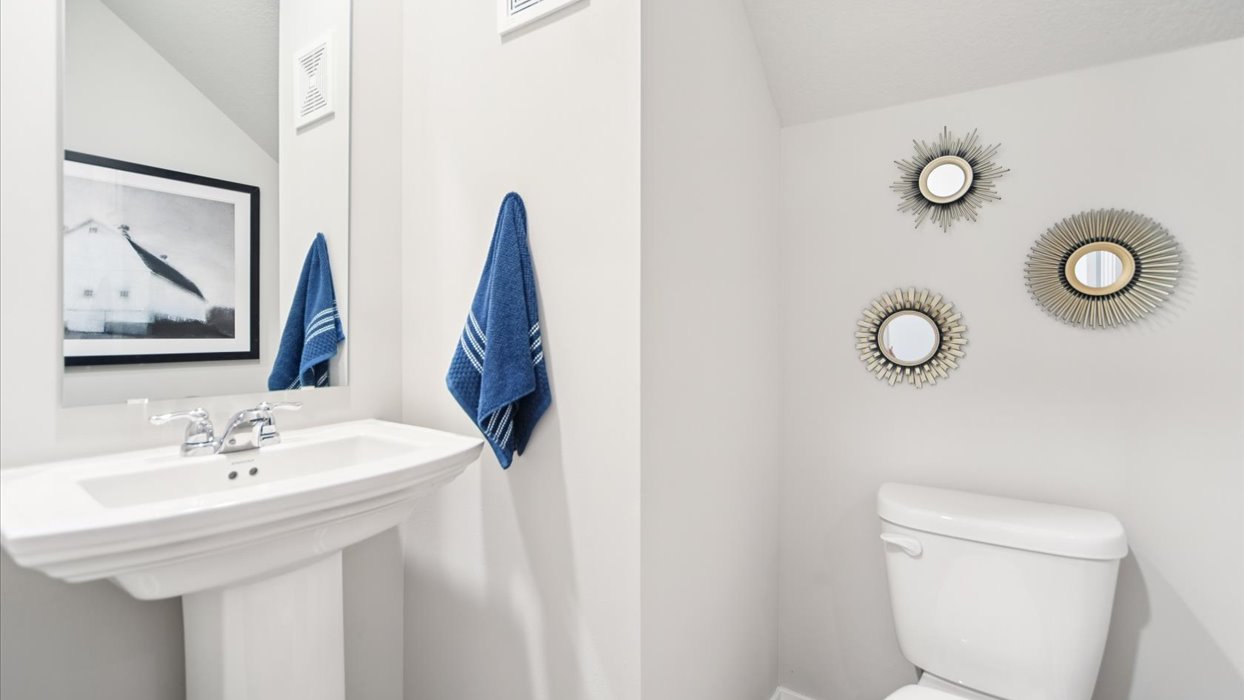 Convenient main-level powder room with updated fixtures and bright lighting.