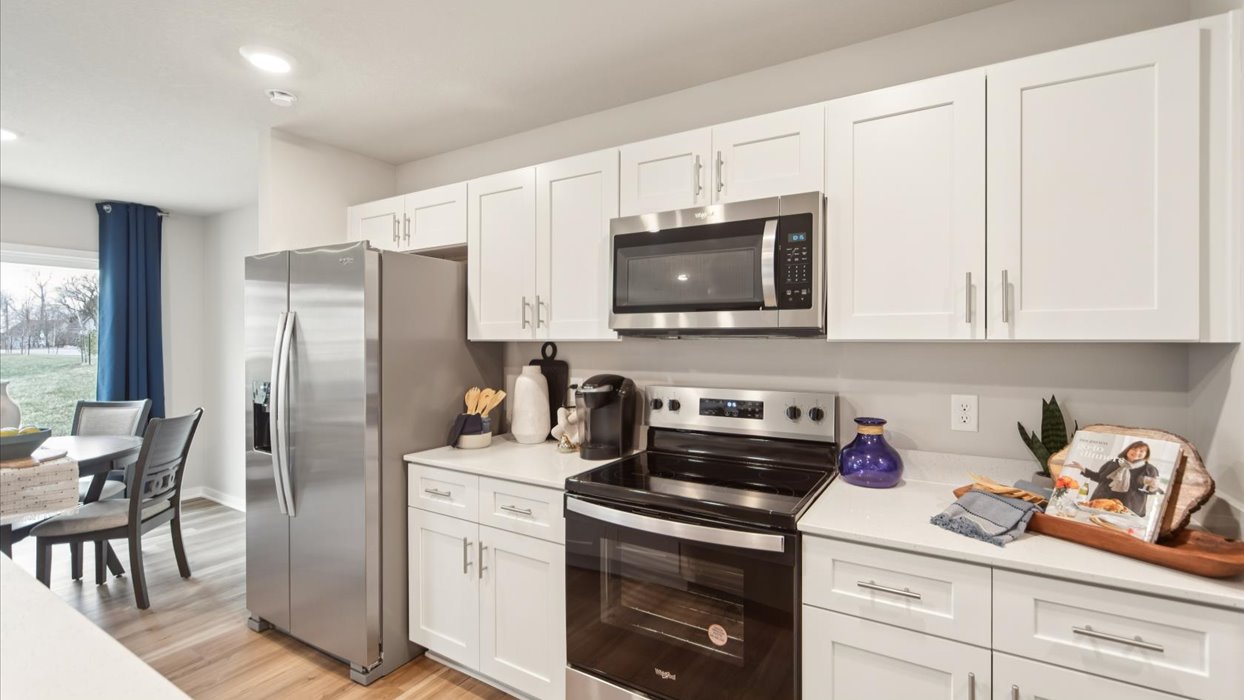 Kitchen with white cabinetry and quartz countertop