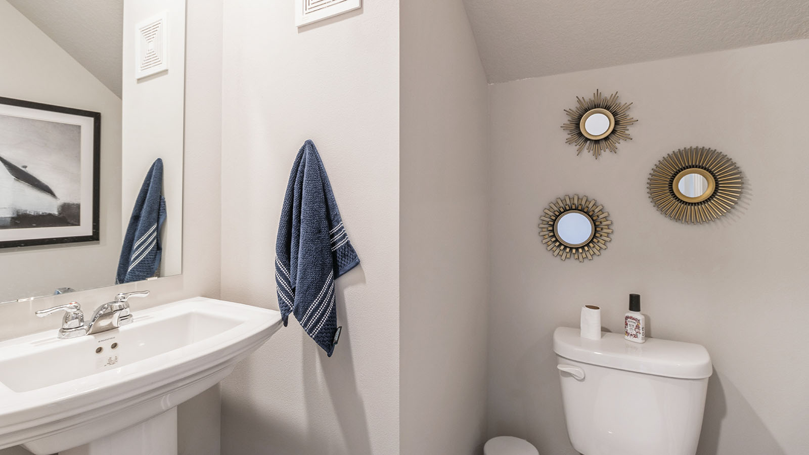 Convenient main-level powder room with updated fixtures and bright lighting.