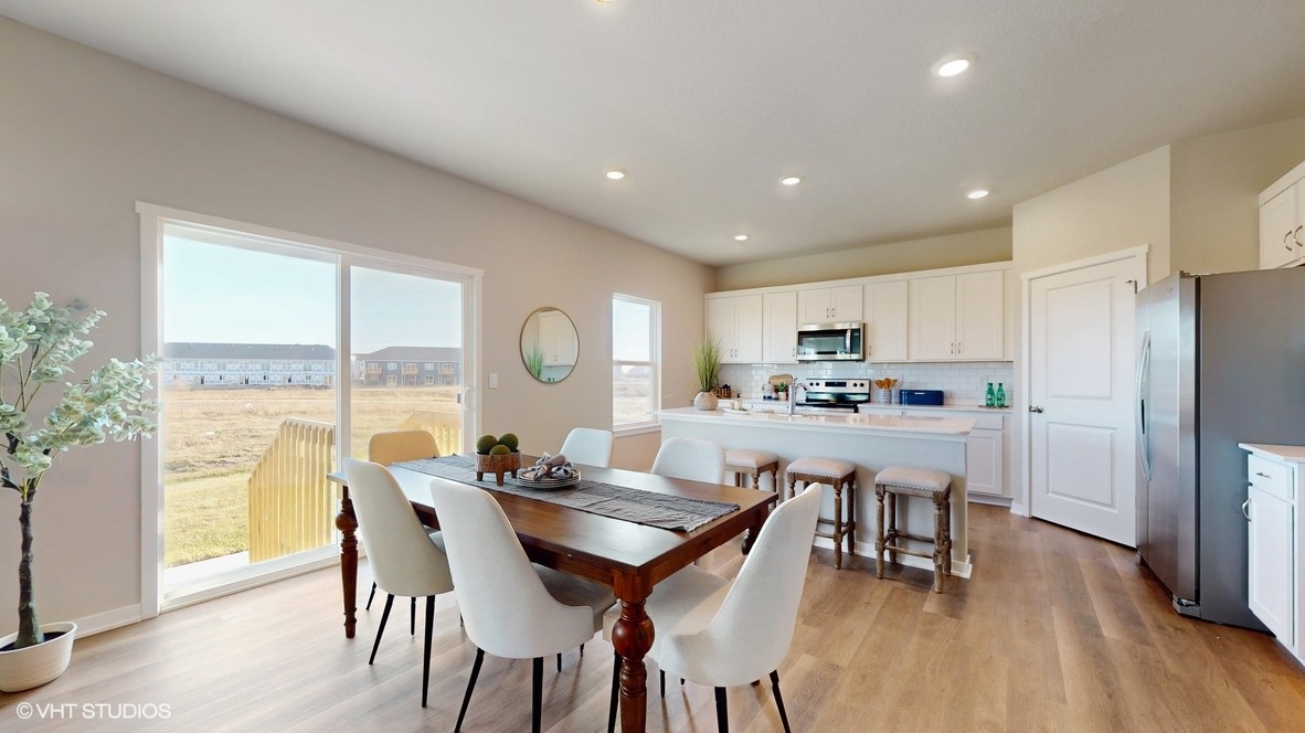 Open concept dining space with access to backyard