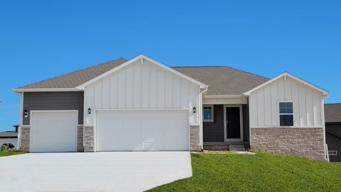 Reagan with white siding, stone and 3 car garage