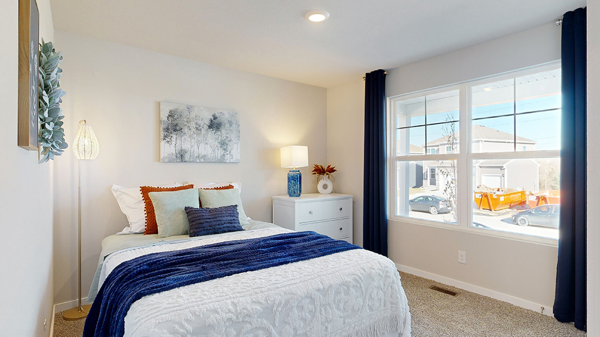 Secondary Bedroom in The Hill includes natural light, soft tones, and sizeable wall space for furniture placement