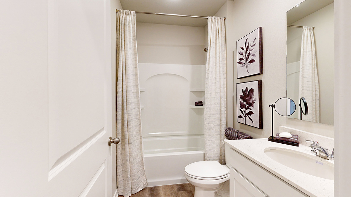 Secondary bath with built-in tub and shower combo, vanity lighting, and stylish finishes in The Hill  - finished basement