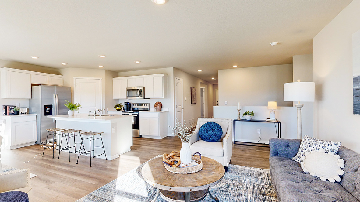 Living room designed by D.R. Horton showcases a new electric fireplace, quality flooring, and access to the kitchen-dining areas