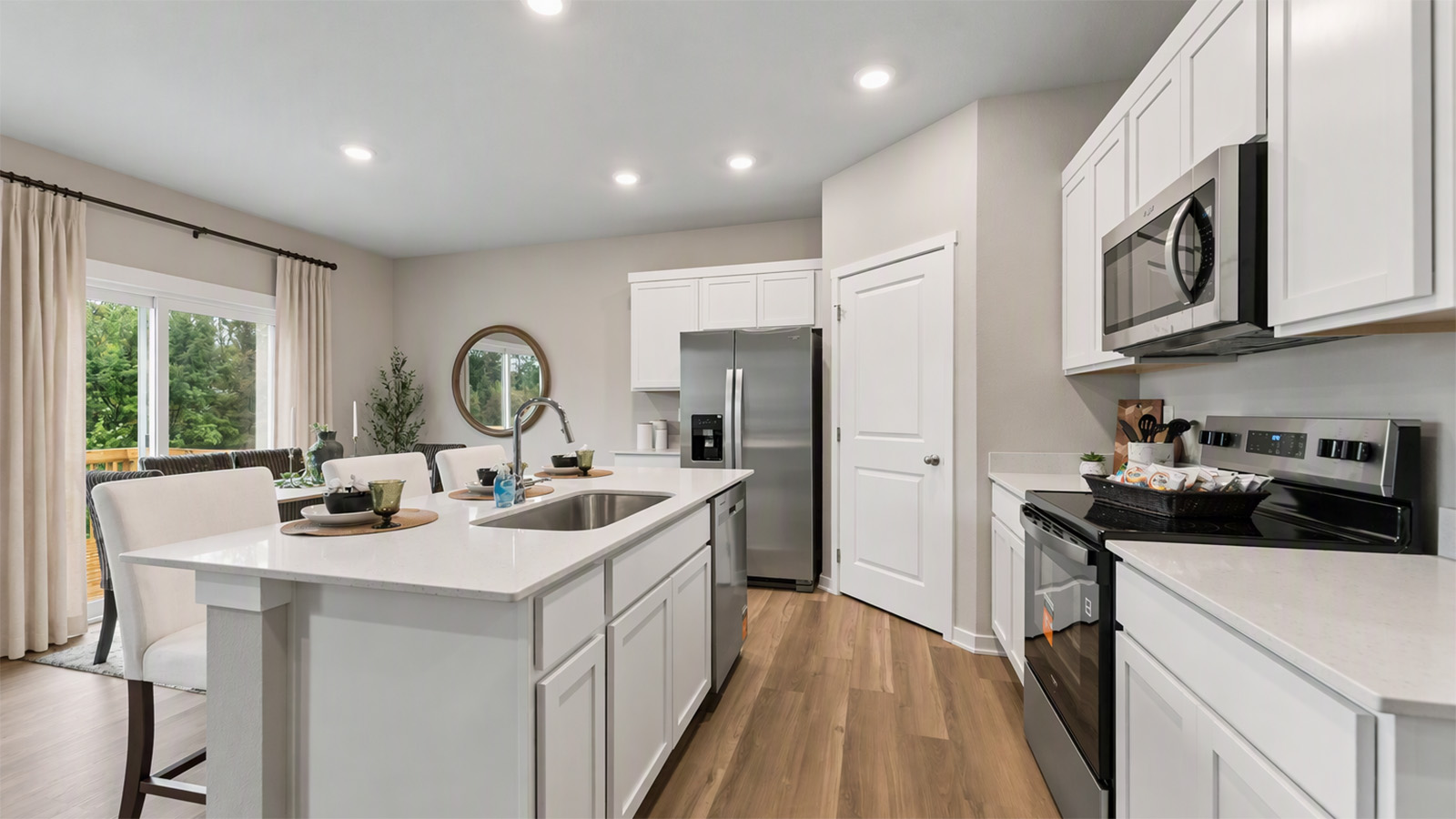 Hamilton kitchen with white cabinets and walk-in pantry looking into the dining area