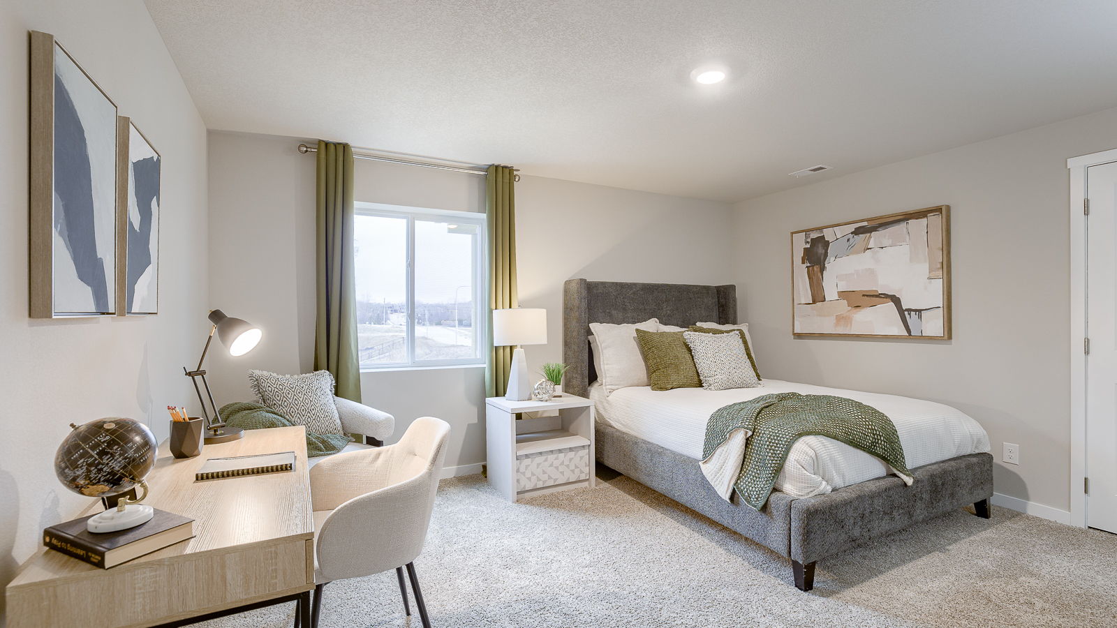Fourth bedroom in the finished basement of the Hamilton with a queen bed and desk
