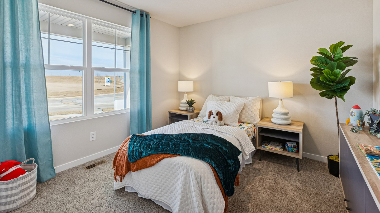 Second bedroom in the Hamilton with twin bed and large window