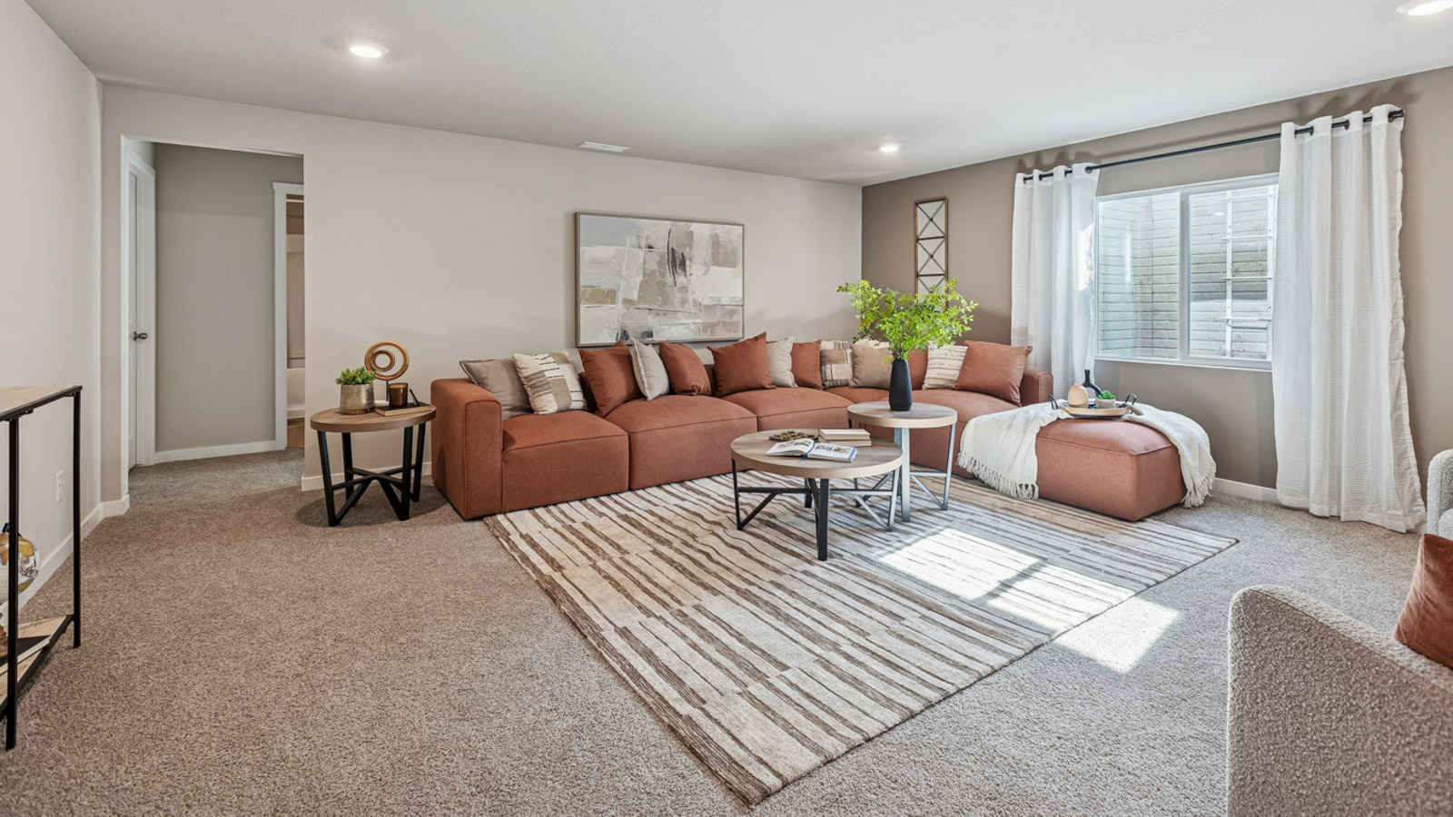 Hamilton finished basement living room with large sectional couch and window