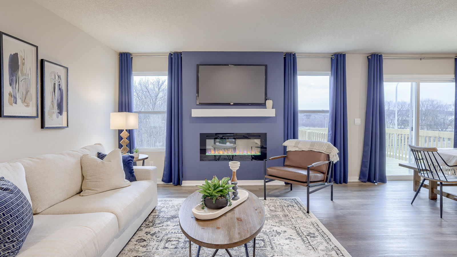 Hamilton living room with an electric fireplace and natural light from large windows