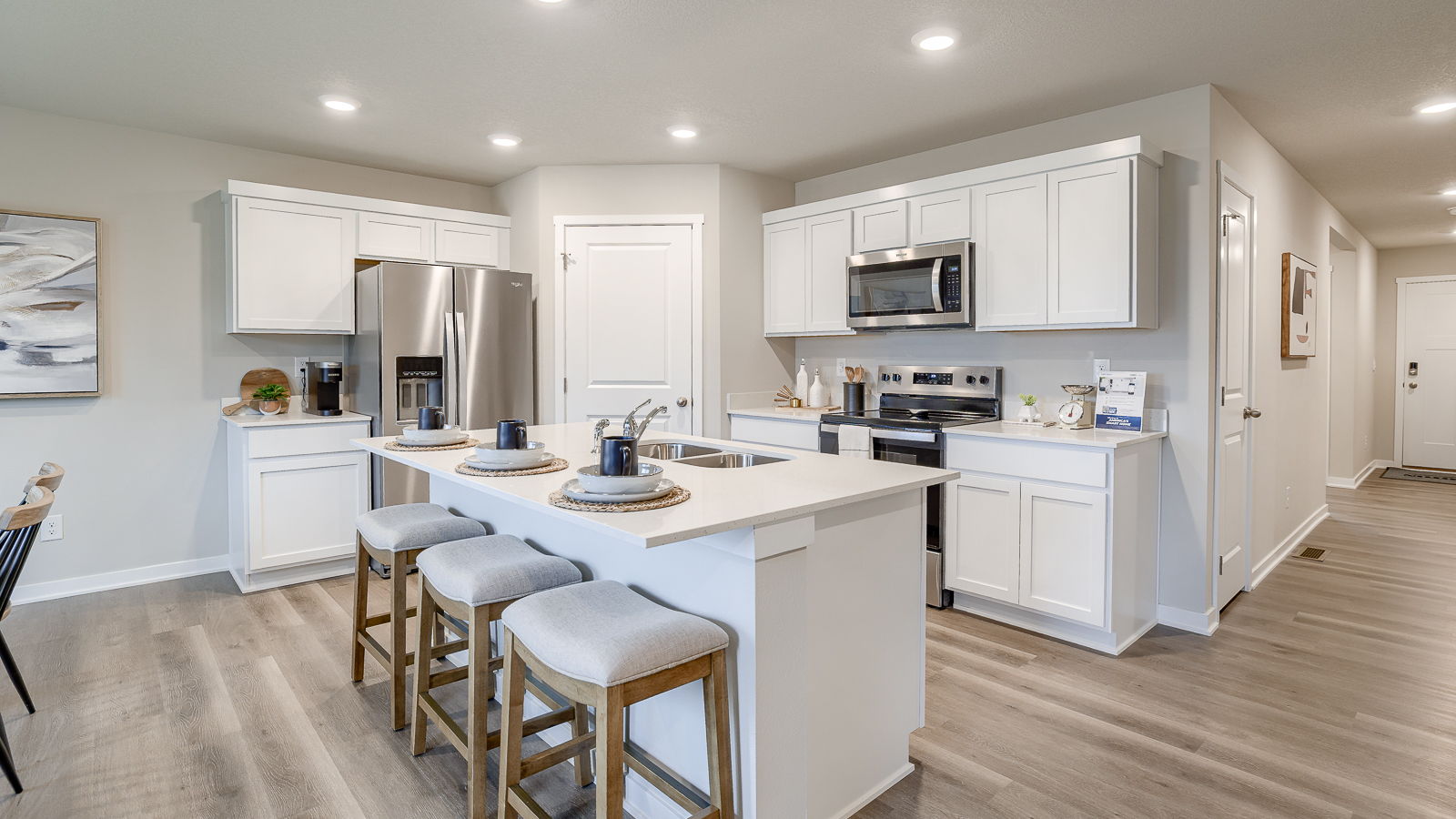 Hamilton kitchen with white cabinets and an island that seats three