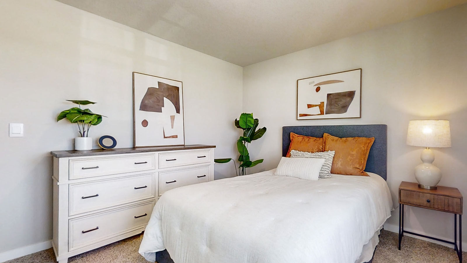 Third bedroom in the Hamilton with a full bed two night stands and a dresser