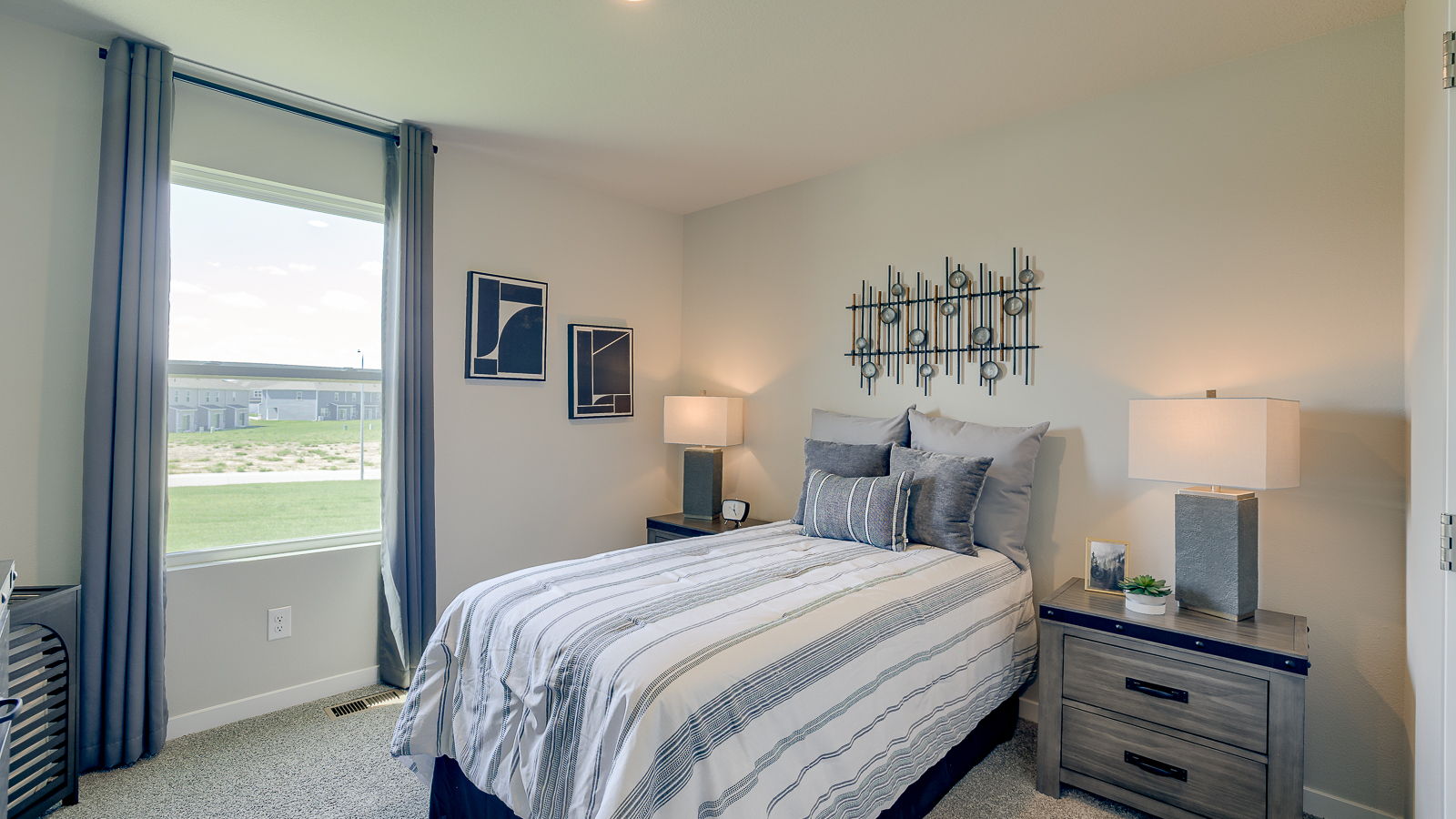 Third bedroom in the Hamilton with twin bed and two night stands