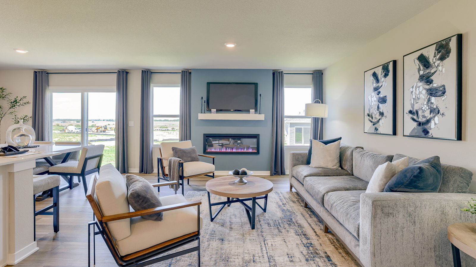 Overview of Hamilton living room with blue accent wall and large windows