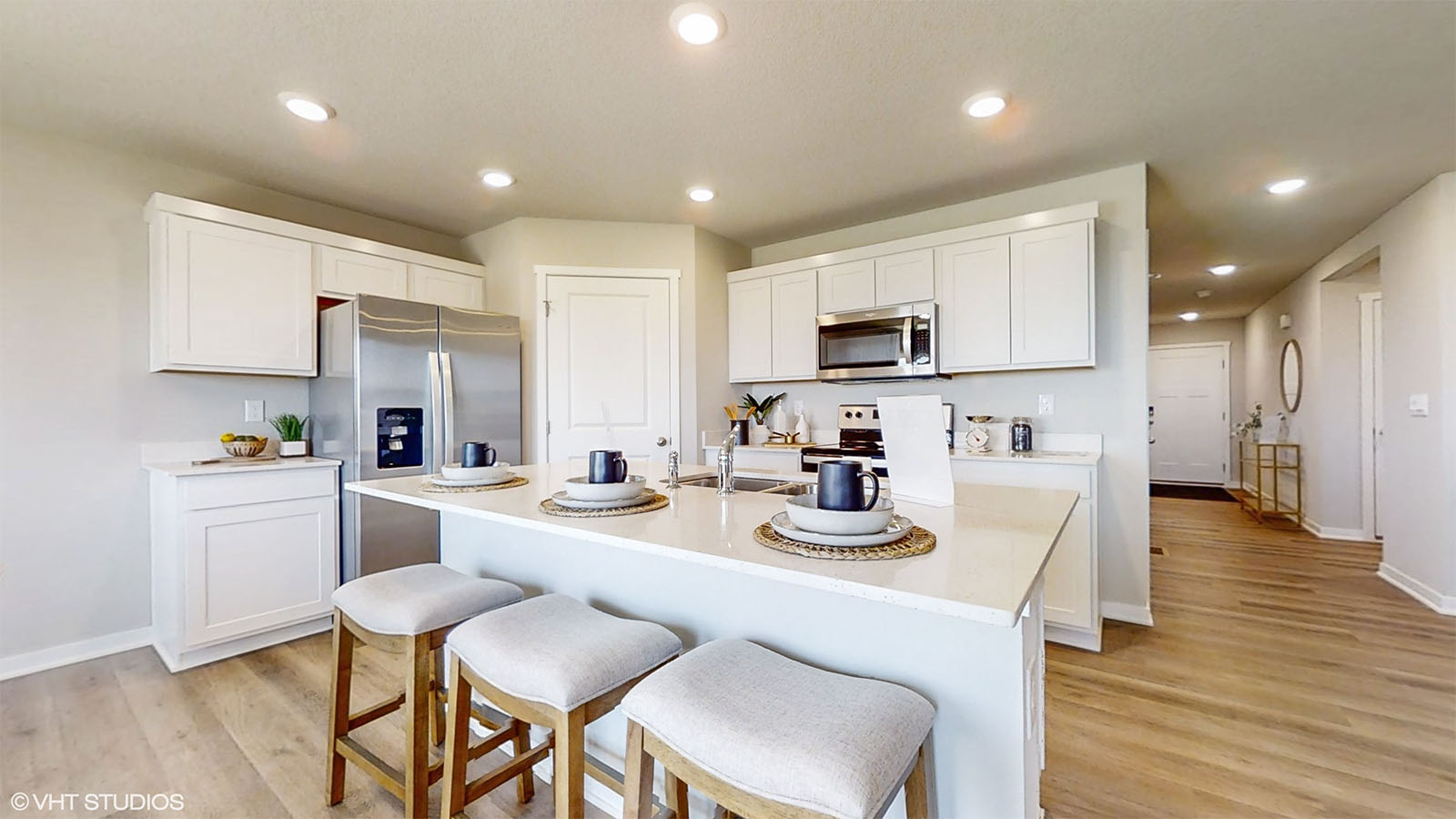 Hamilton kitchen with white cabinets and large island with 3 chairs