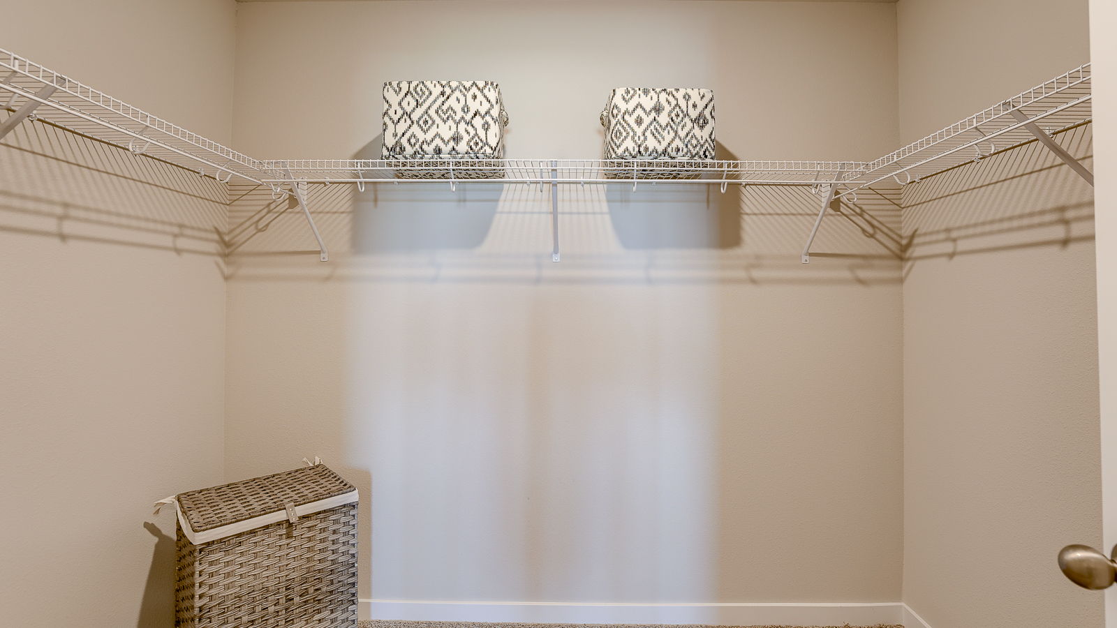 Primary closet in Hamilton with shelf and clothes hamper