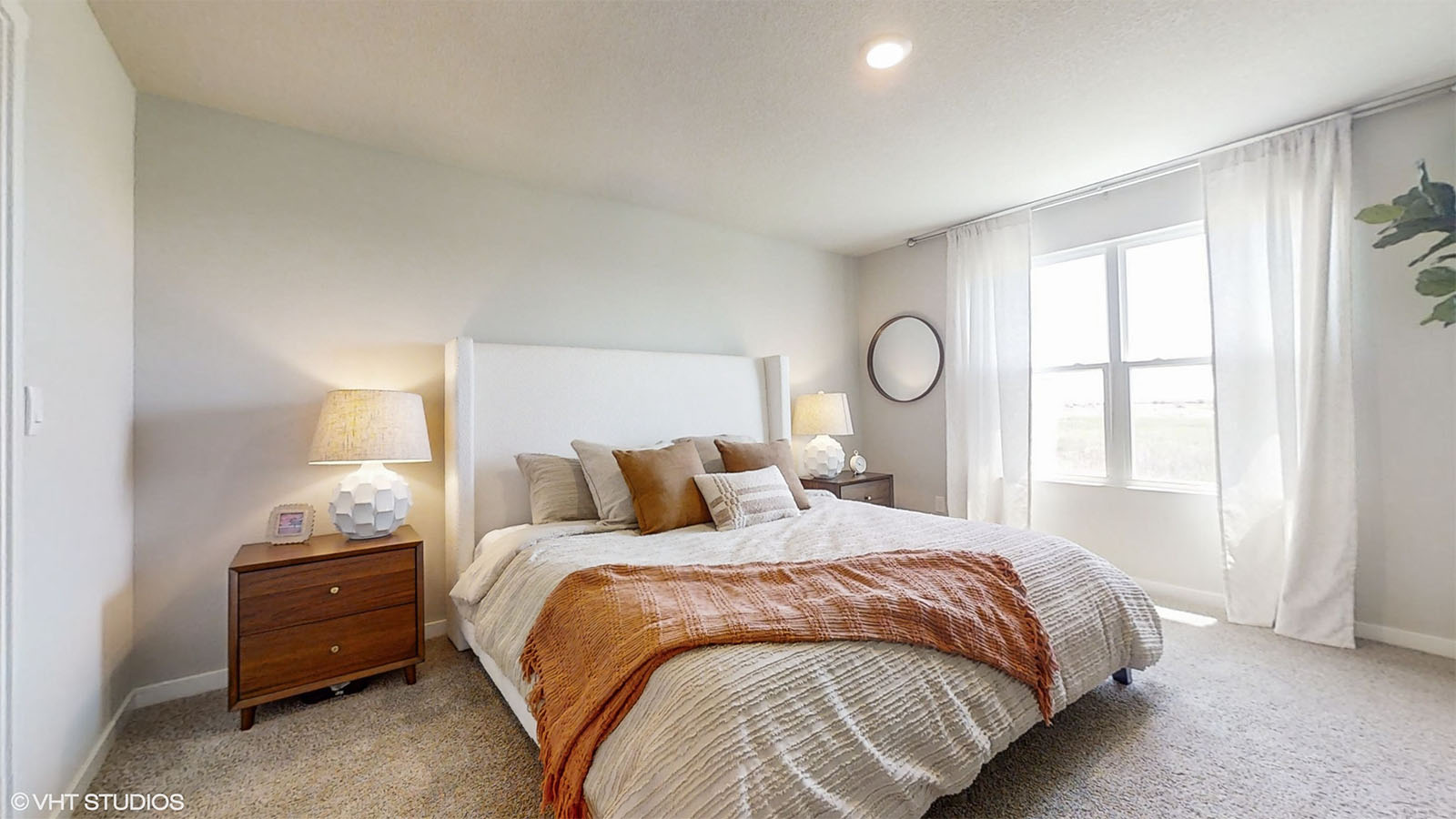 Primary bedroom features ample space, double windows, soft carpet, a stylish walk-in closet, and a private ensuite bath