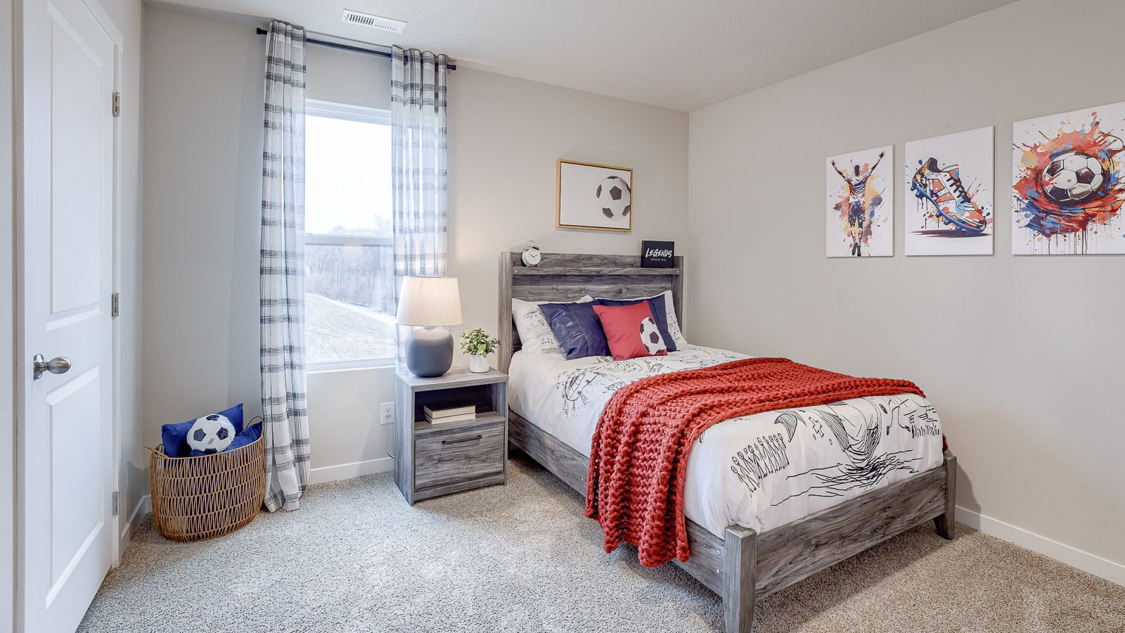 Second bedroom in the Bellhaven with a window for natural light and staged in a soccer theme