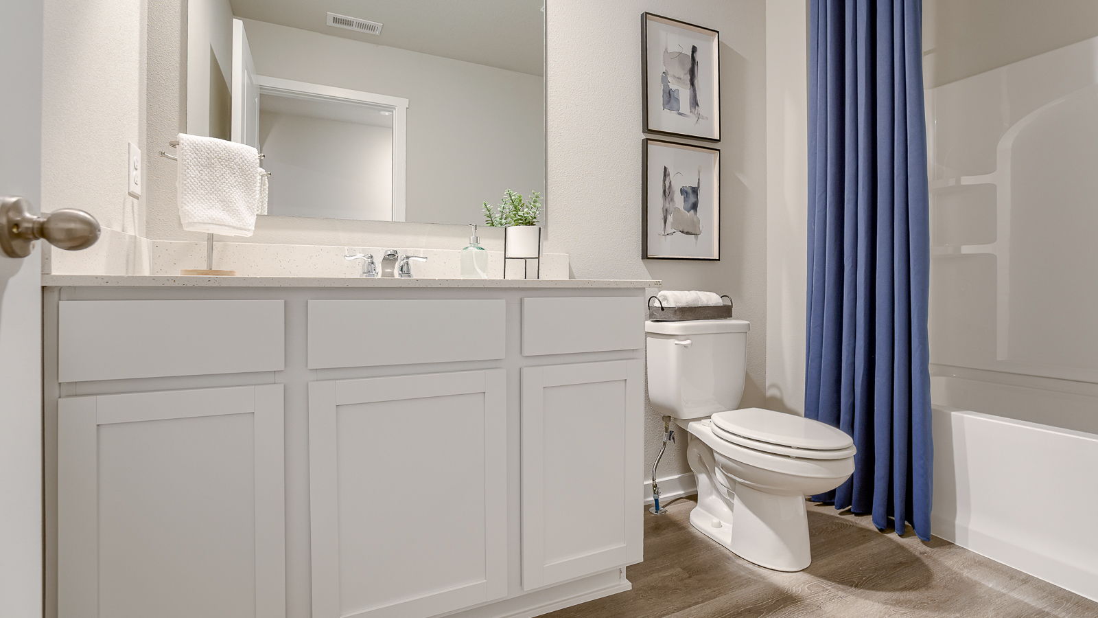 Second full bathroom in the Bellhaven with a bathtub sink toilet and white cabinets