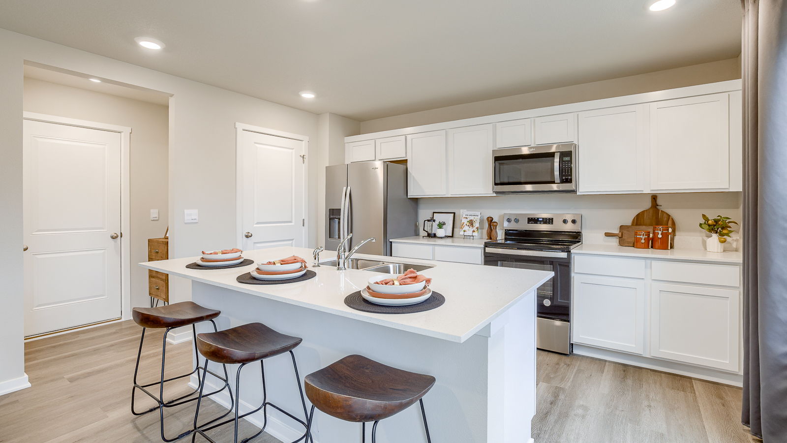 Bellhaven kitchen with island 3 stools and white cabinets