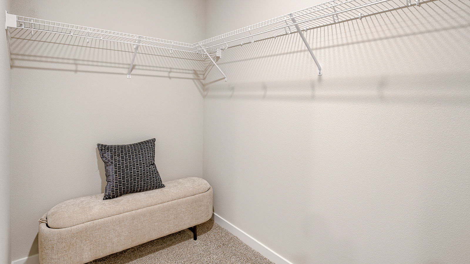 Spacious walk-in closet off primary bedroom with shelving