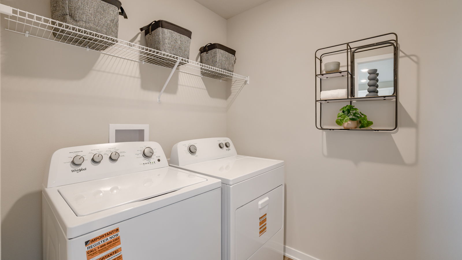 Laundry room of Neuville  with overhead storage shelf