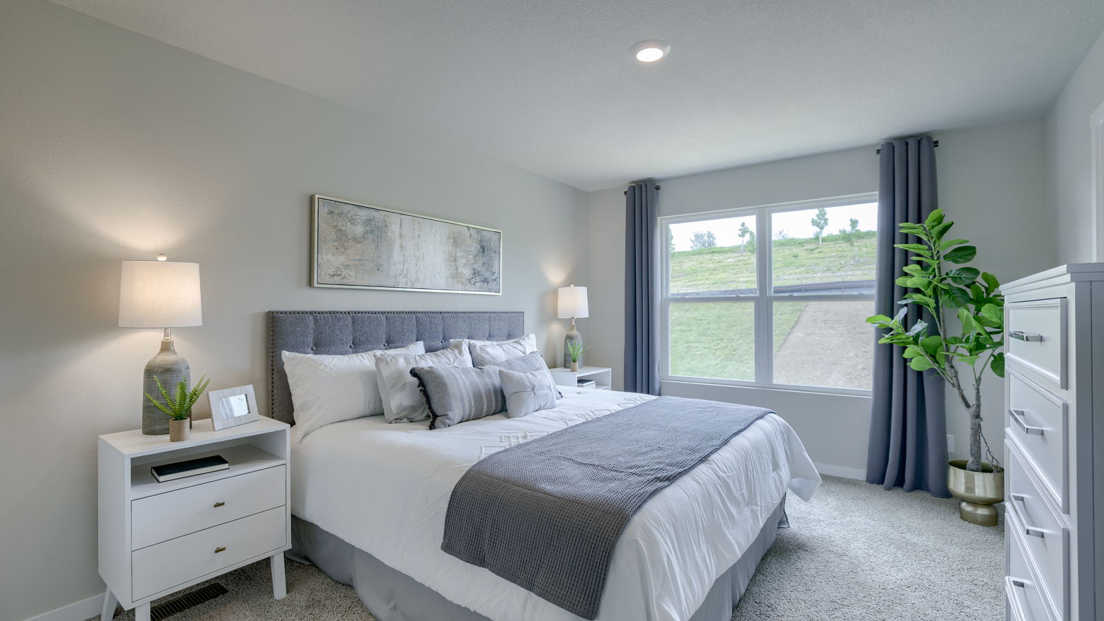 Primary bedroom in the Fremont with natural lighting from the large window