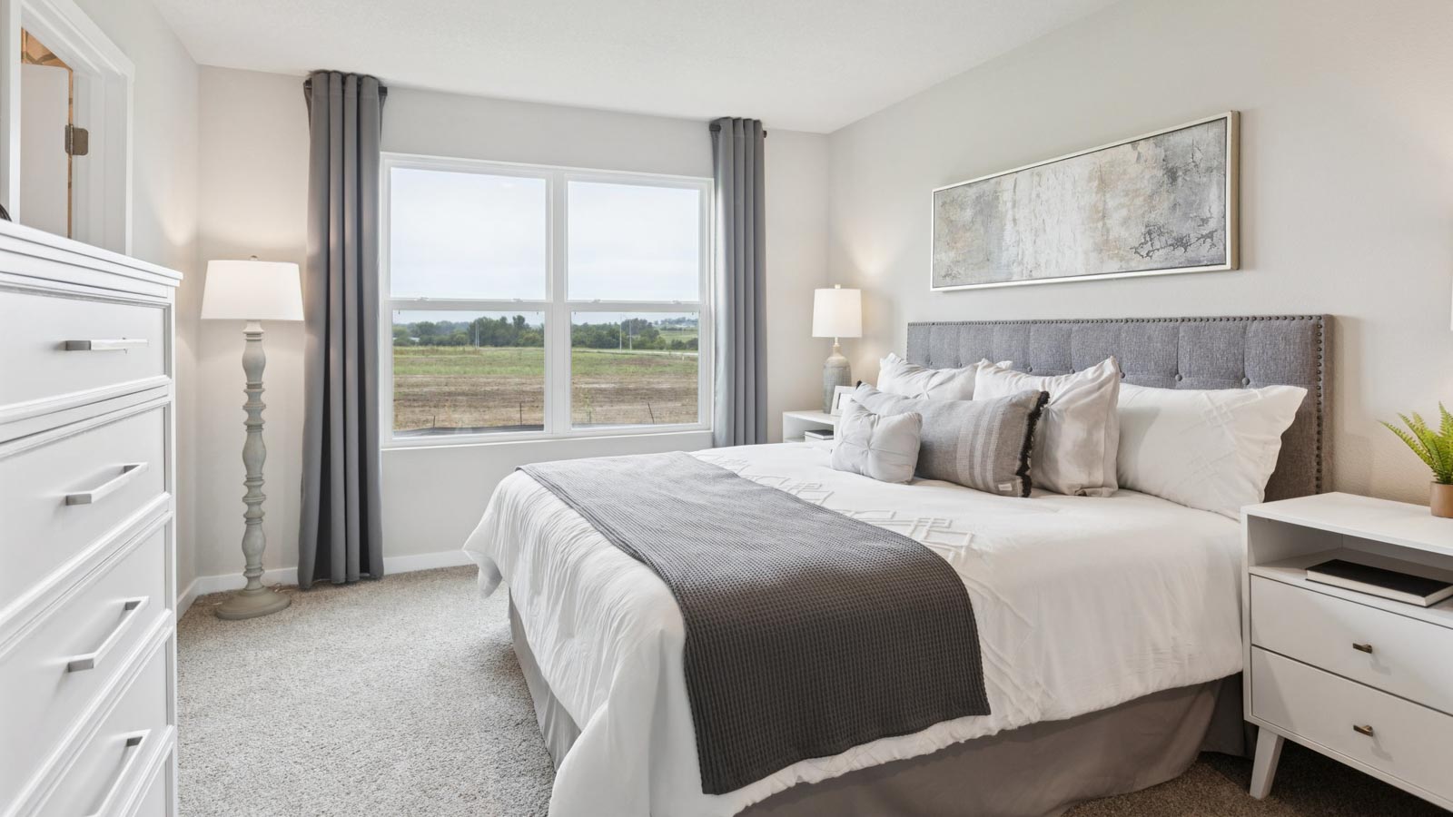 Primary bedroom in the Fremont with a king bed and large windows