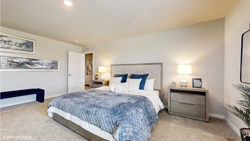 Spcaious primary bedroom with large king sized bed and oversized nightstands