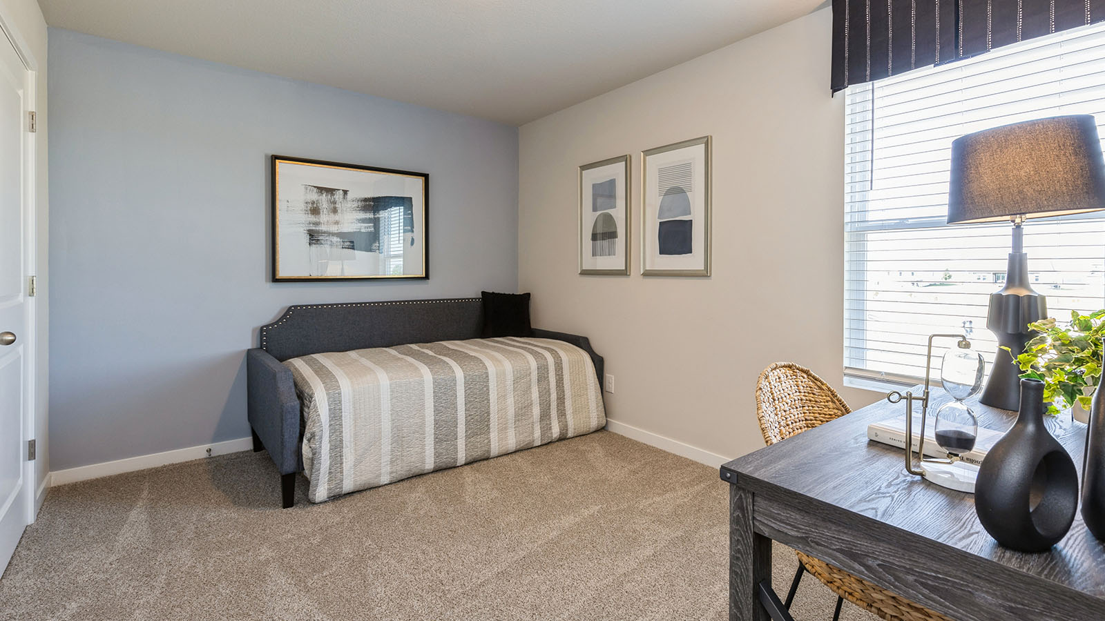 Guest bedroom with twin day bed and small desk to show flexibility of the space