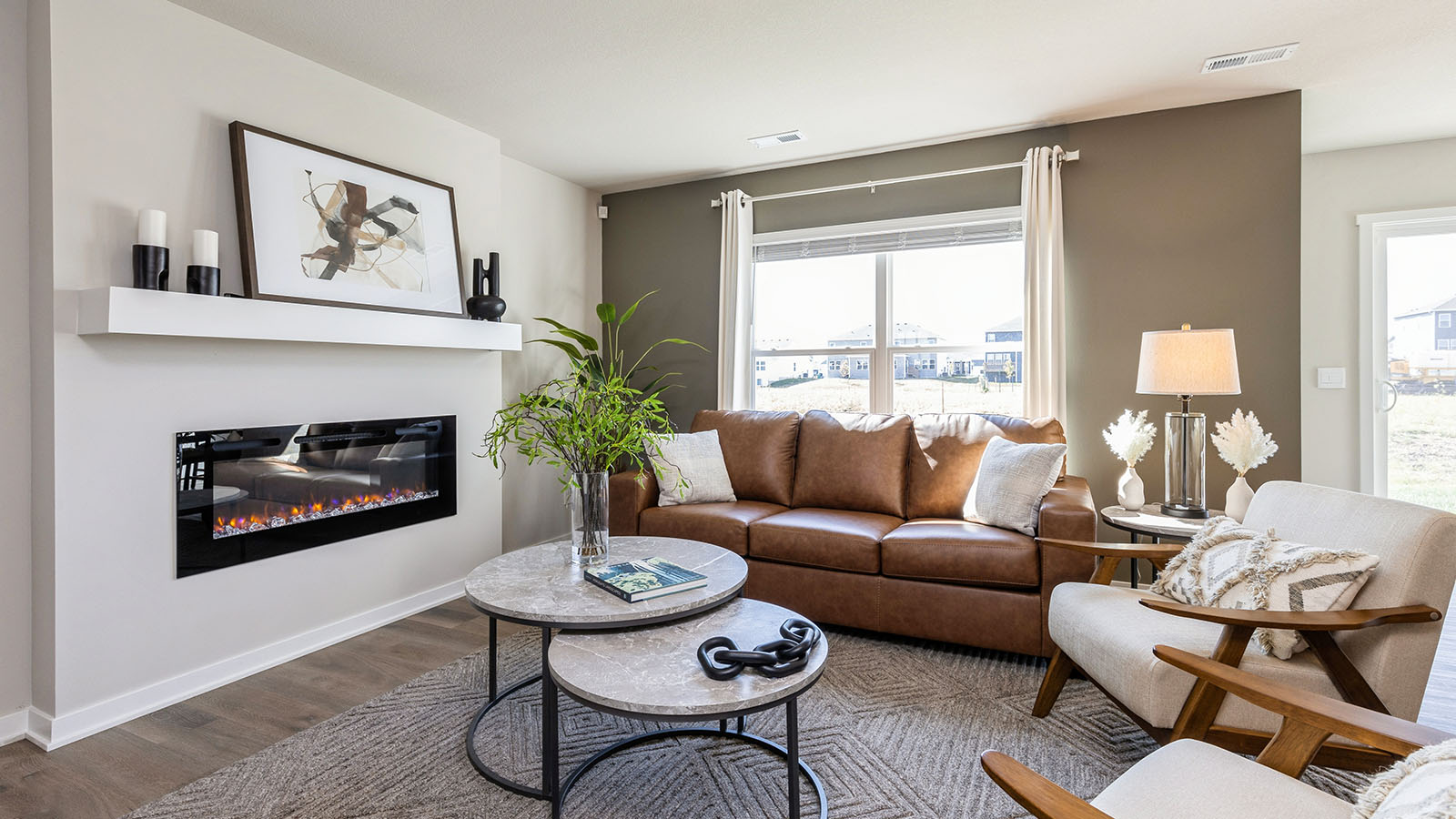 Cozy livingroom with large window and built in electric fireplace