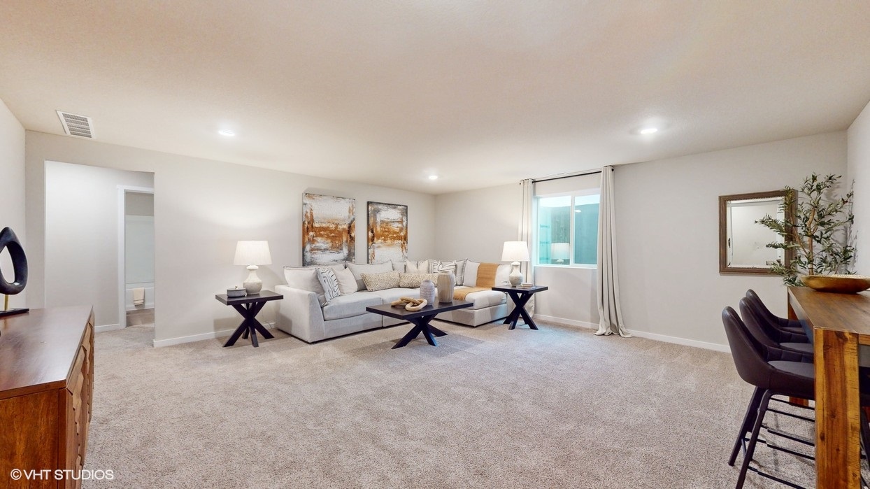 Finished basement with seating and overhead lighting