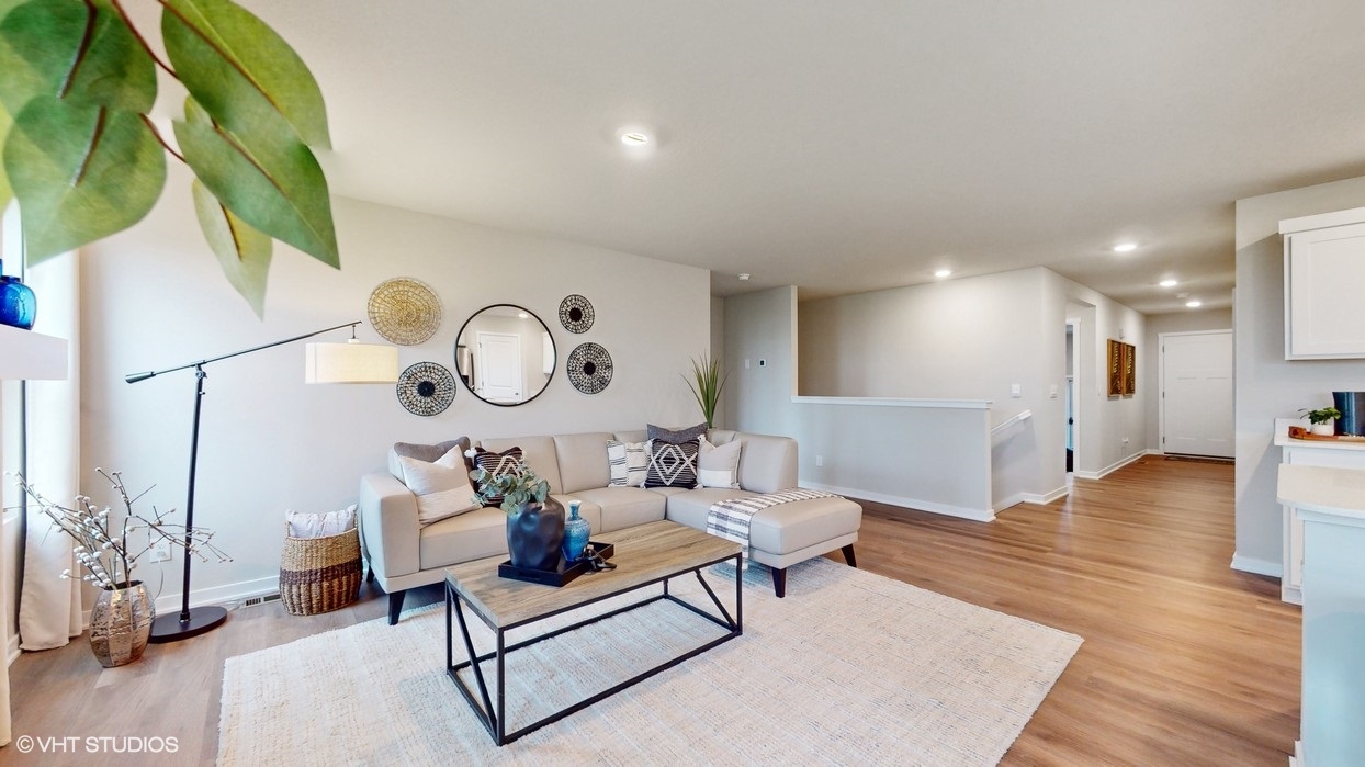 Harmony living room with large area rug and brown coffee table