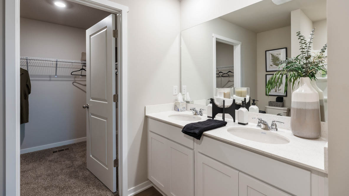 Primary bathroom with large mirror and two sinks