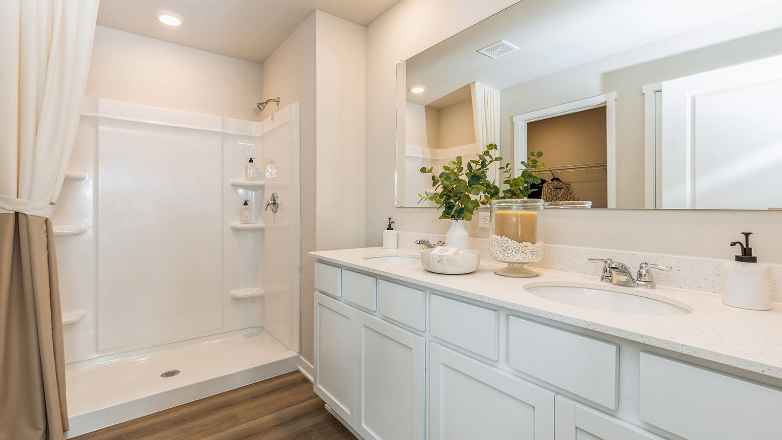 Primary bathroom with dual sinks and large mirror
