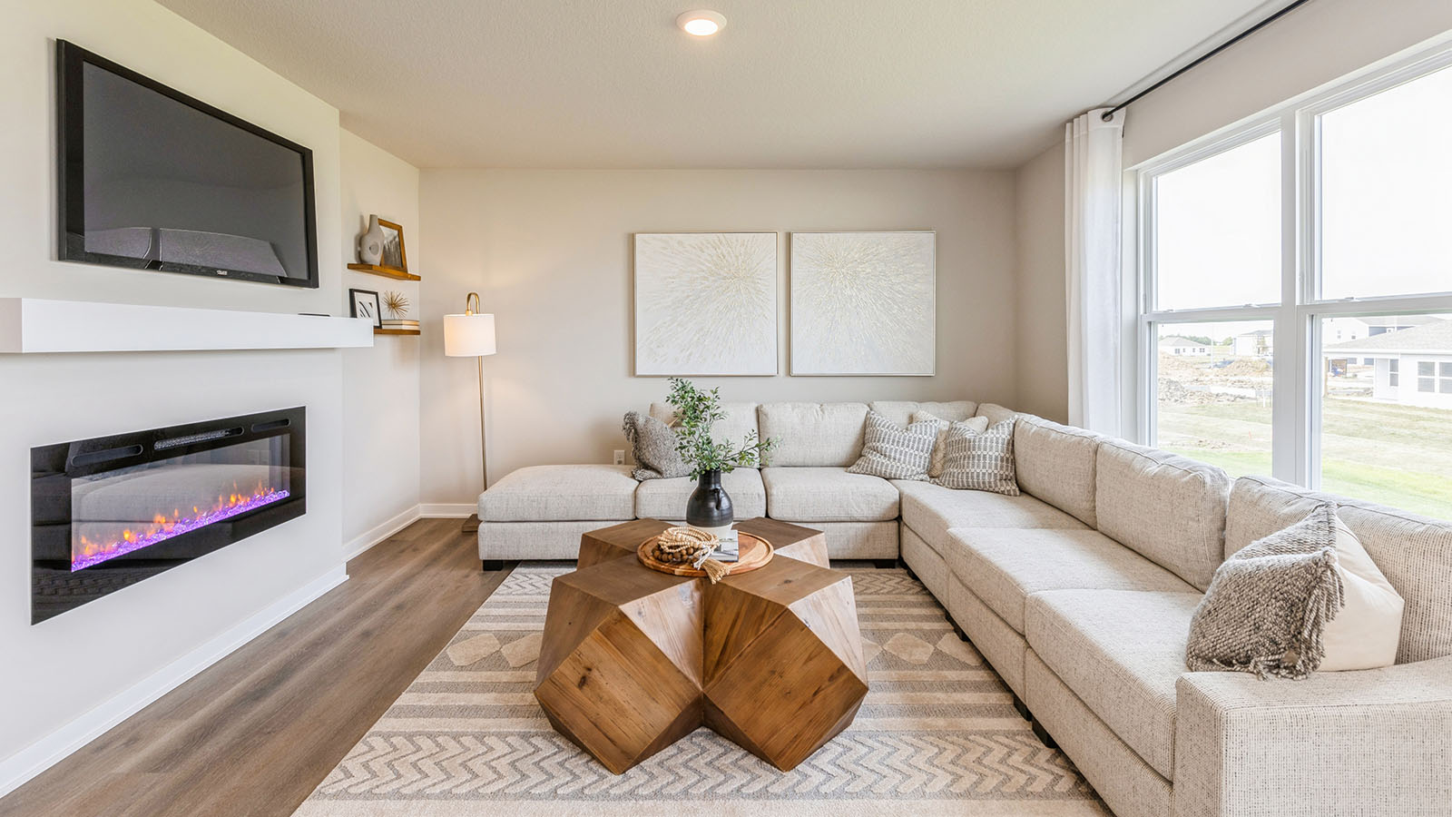 Spacious living room with mounted tv and electric fireplace