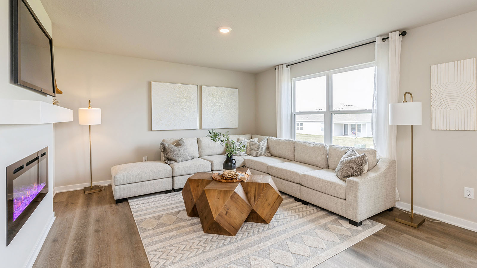 Living room with large window and tan couch