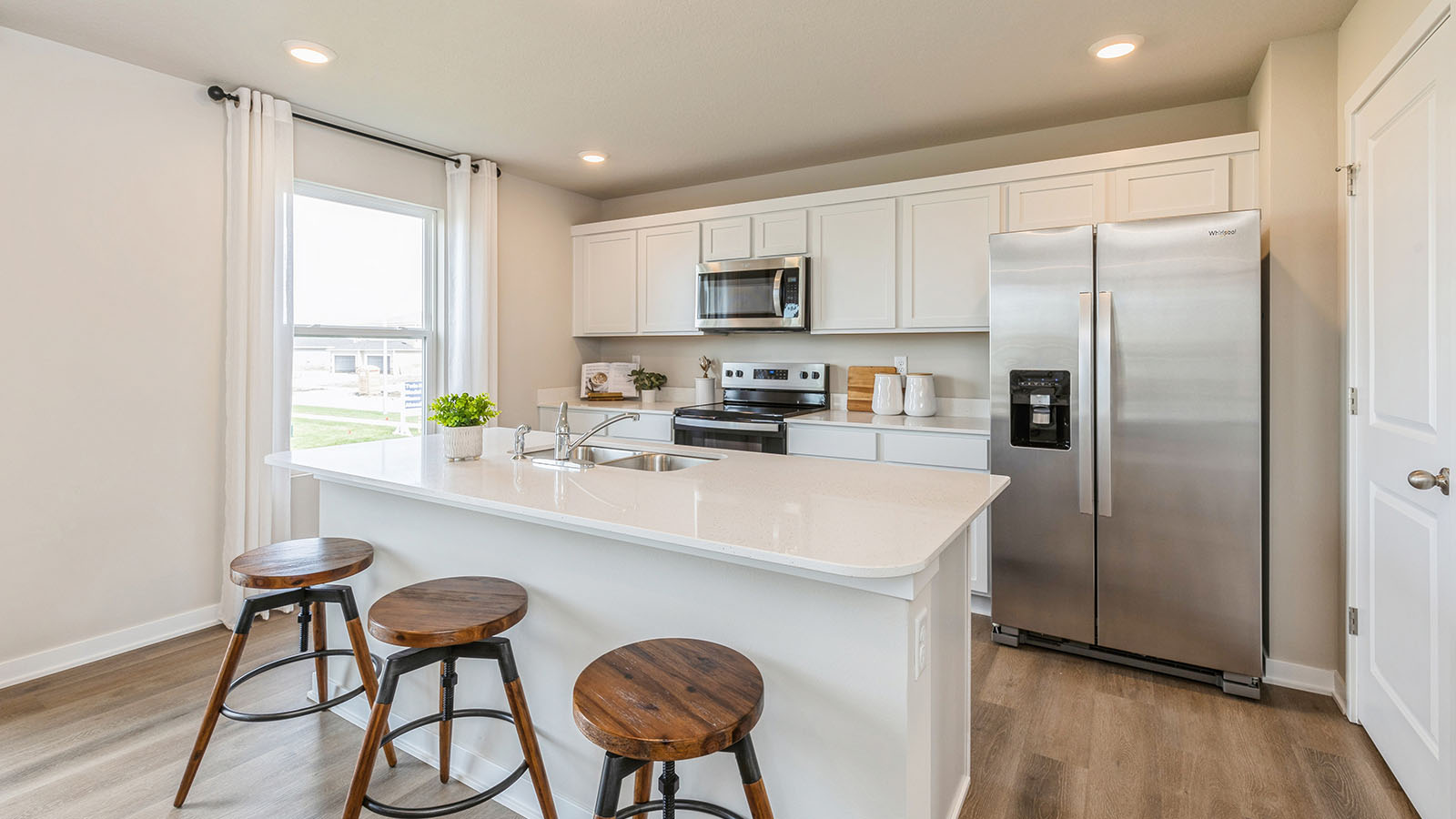 Kitchen with white cabinetry and small window
