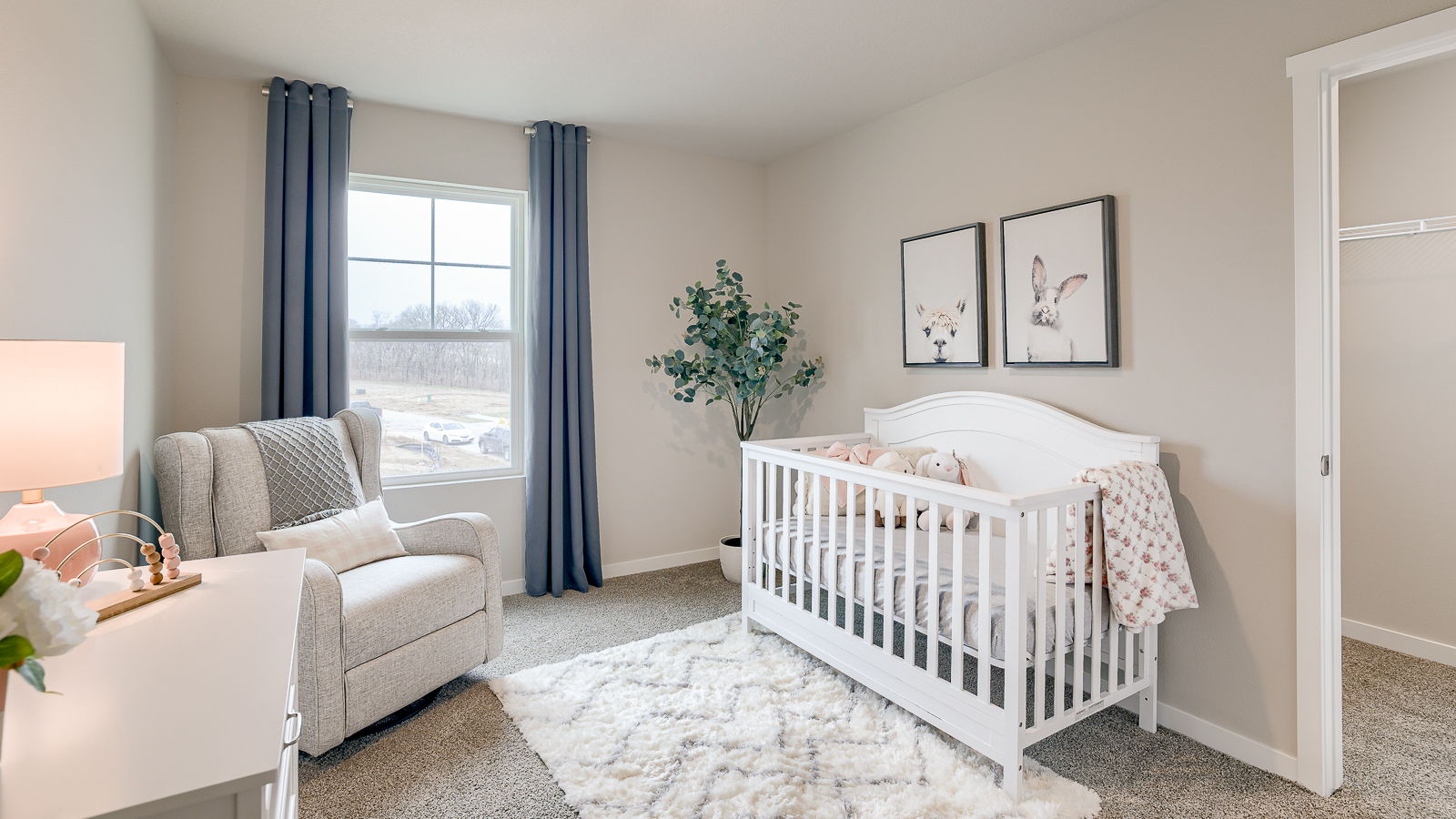 Secondary bedroom in sydney townhome with large walk in closet staged as a girls nursery