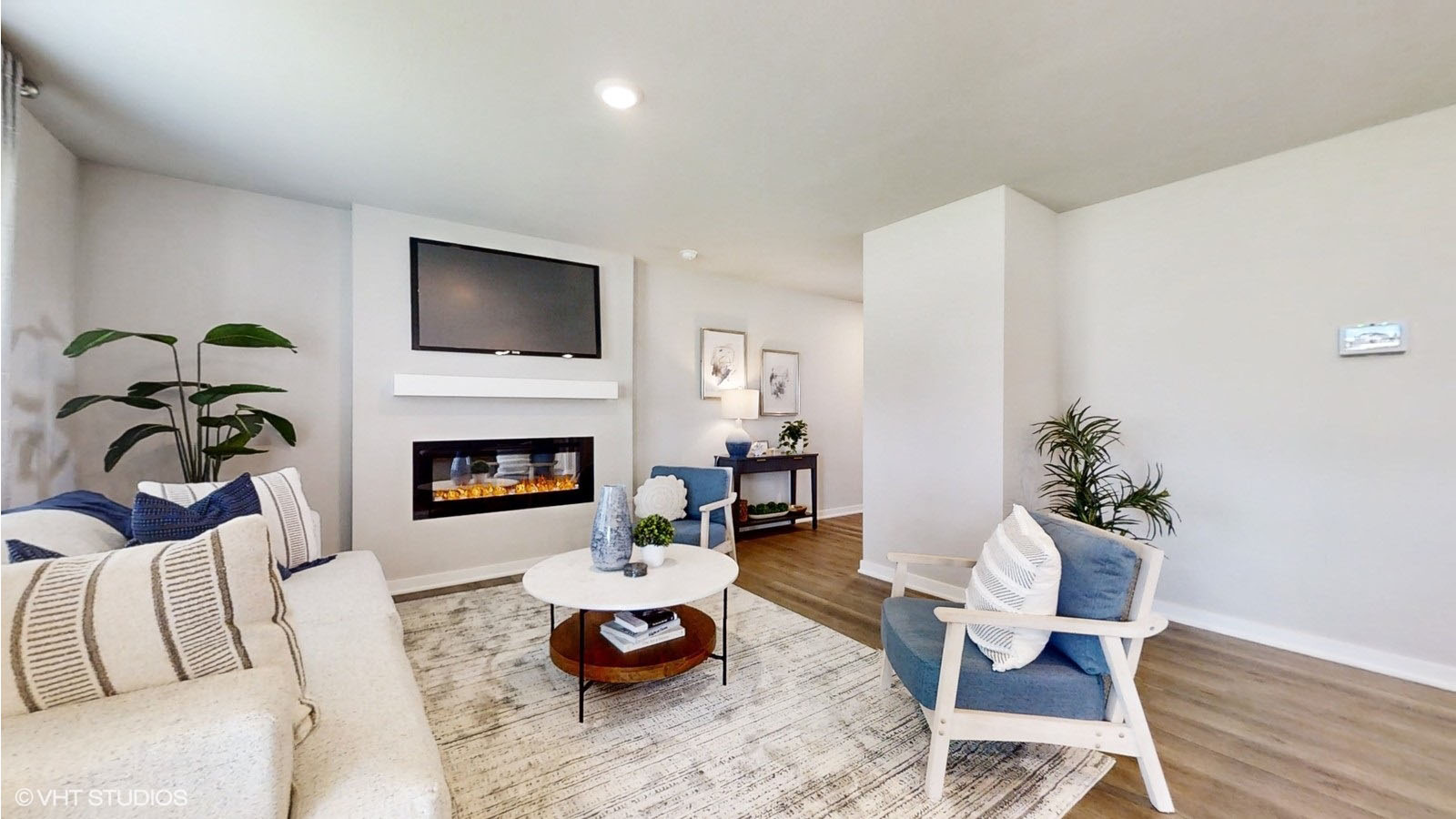 living room in the Sydney with couch and two chairs with a fireplace