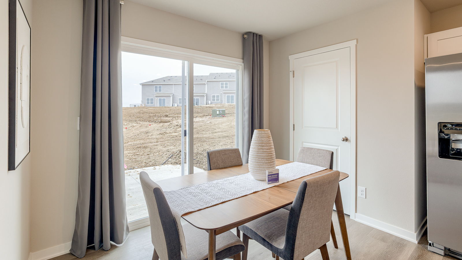dining room of sydney with 4 chairs and a sliding glass door to back yard