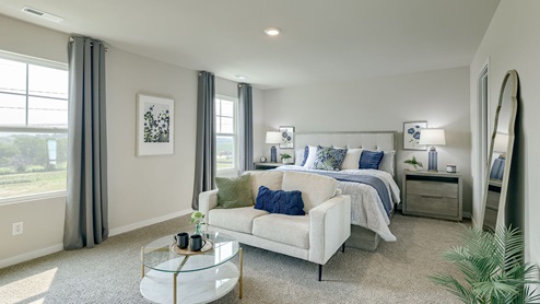 Large Primary bedroom in the Bellhaven showing a sitting area