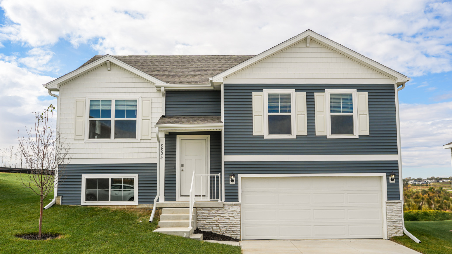 Exterior of split level fremont floor plan, 2 car garage and grey siding