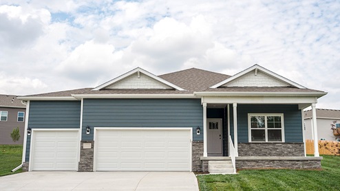 exterior of hamilton with blue siding, stone and 3 car garage