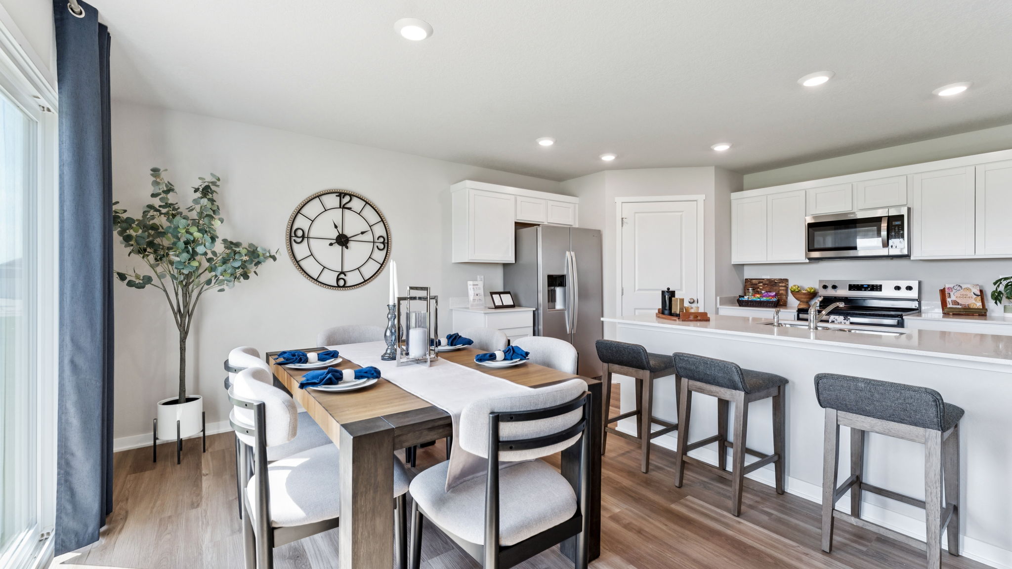 Dining area in the Hamilton with table and six chairs looking into the kitchen