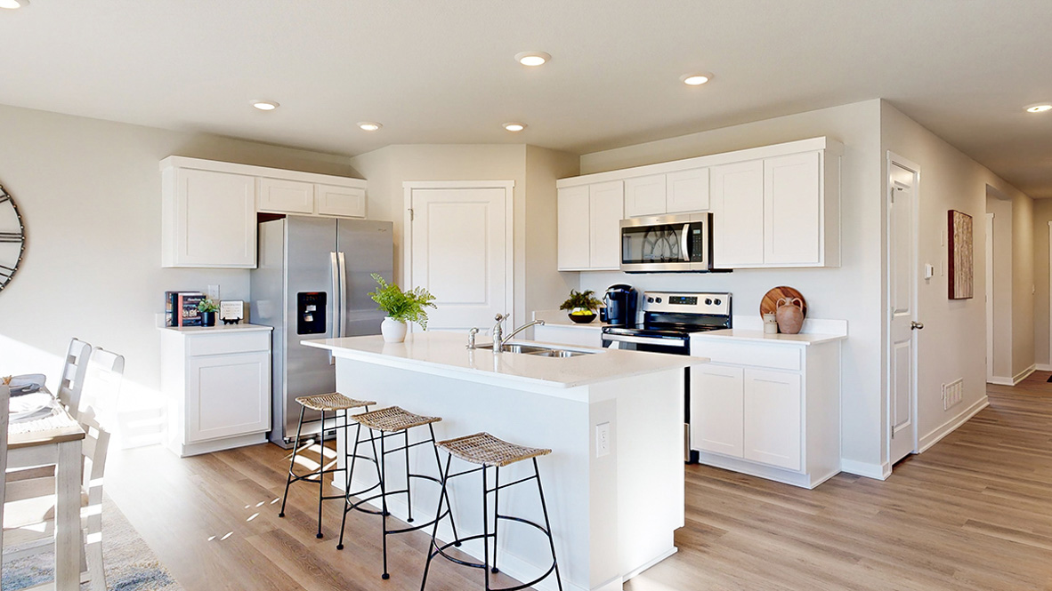 Hamilton kitchen with white cabinets and a center island with three stools