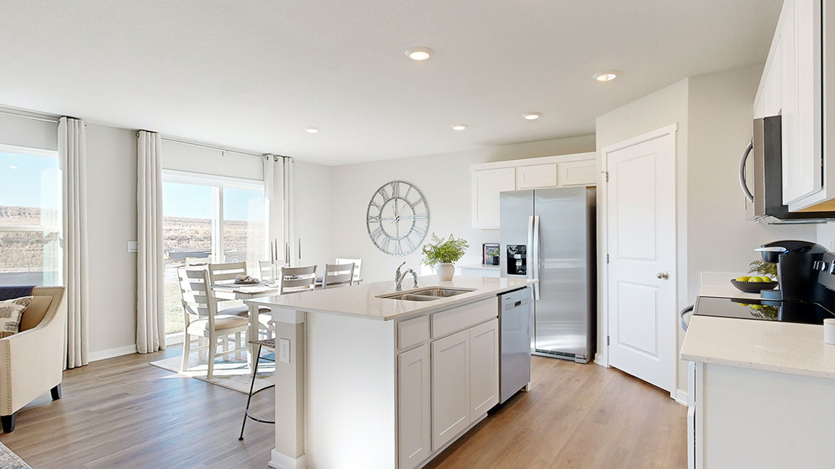 Hamilton kitchen with stainless steel appliances looking into the dining area
