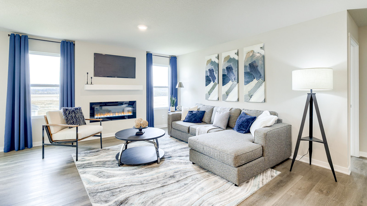Living room with fireplace and opening windows for natural lighting