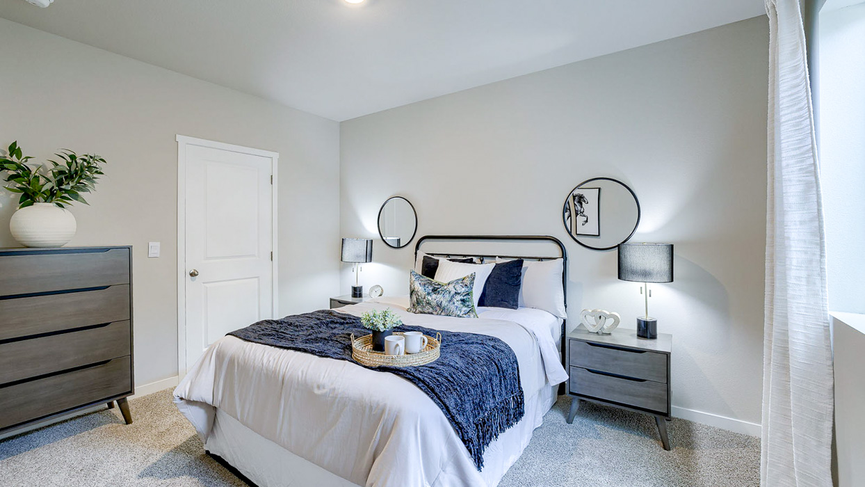 Fifth bedroom in Bellhaven finished basement with queen bed dresser and nightstand